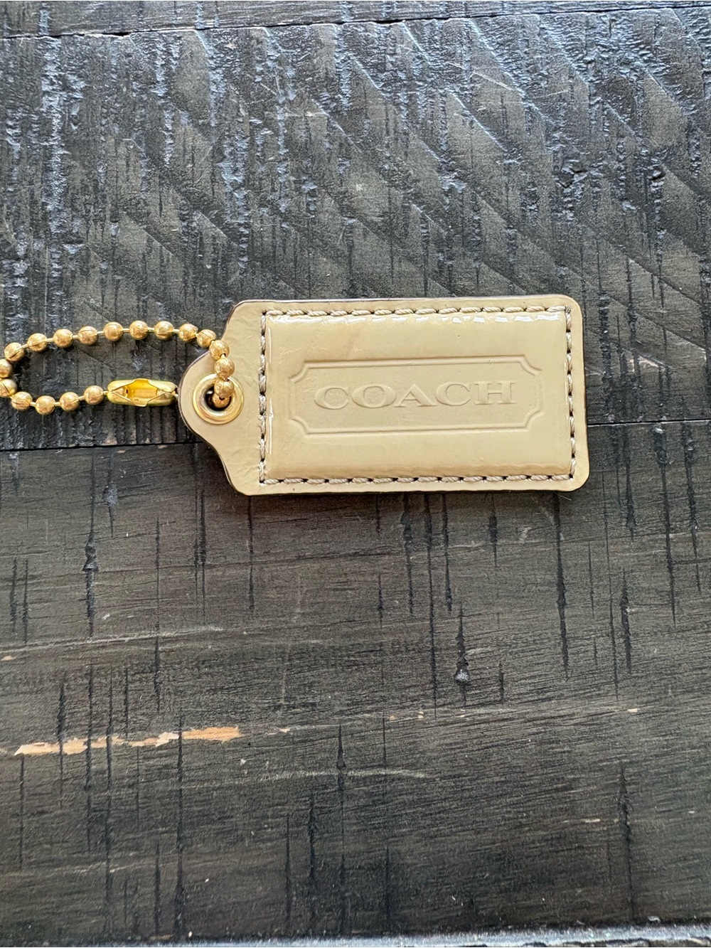 COACH Beige Patent Leather Hang Tag with Gold Bead Chain 2.5x1.25”